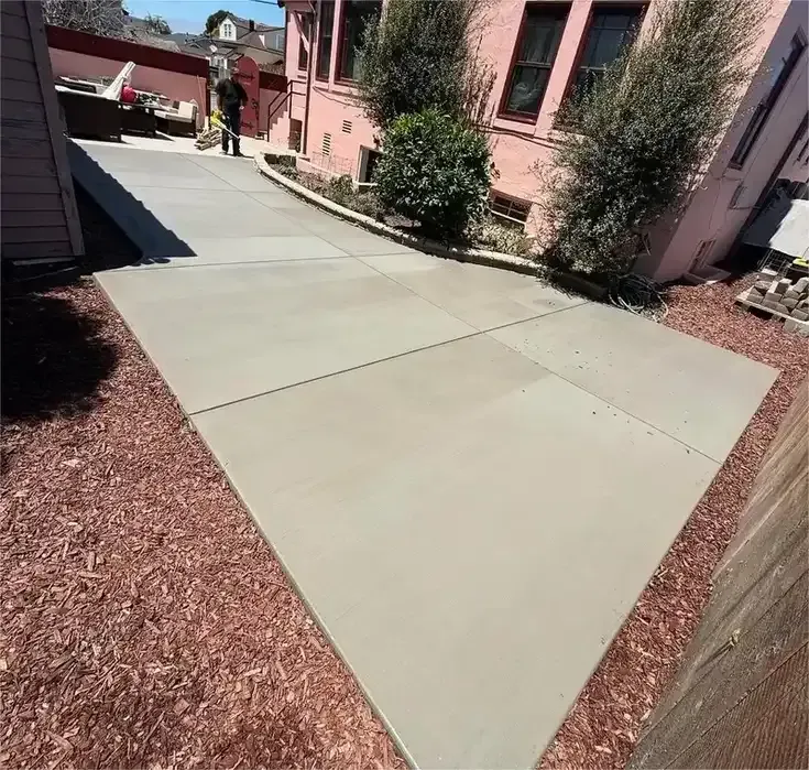 New concrete walkway beside a residential building